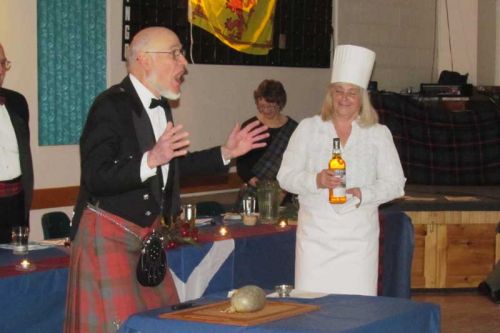 Gordon Sparks, addressing the haggis, and Pat Cuddy offering a wee dram. 