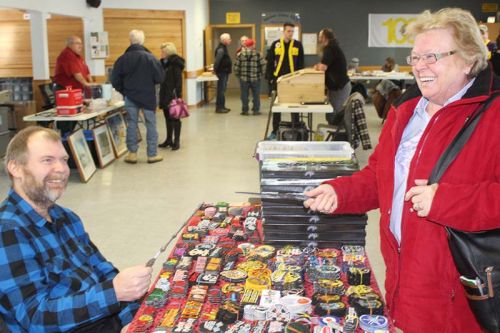 Pat Willman and Sheila Calthorpe face off in a wizard’s duel with the Harry Potter wands Willman was selling at the Verona Lions Vendors Market Saturday in Verona. Photo/Craig Bakay